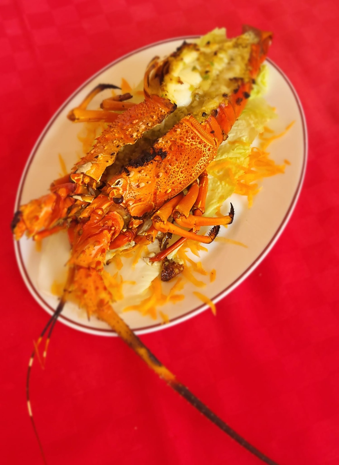 Whole grilled lobster on a platter